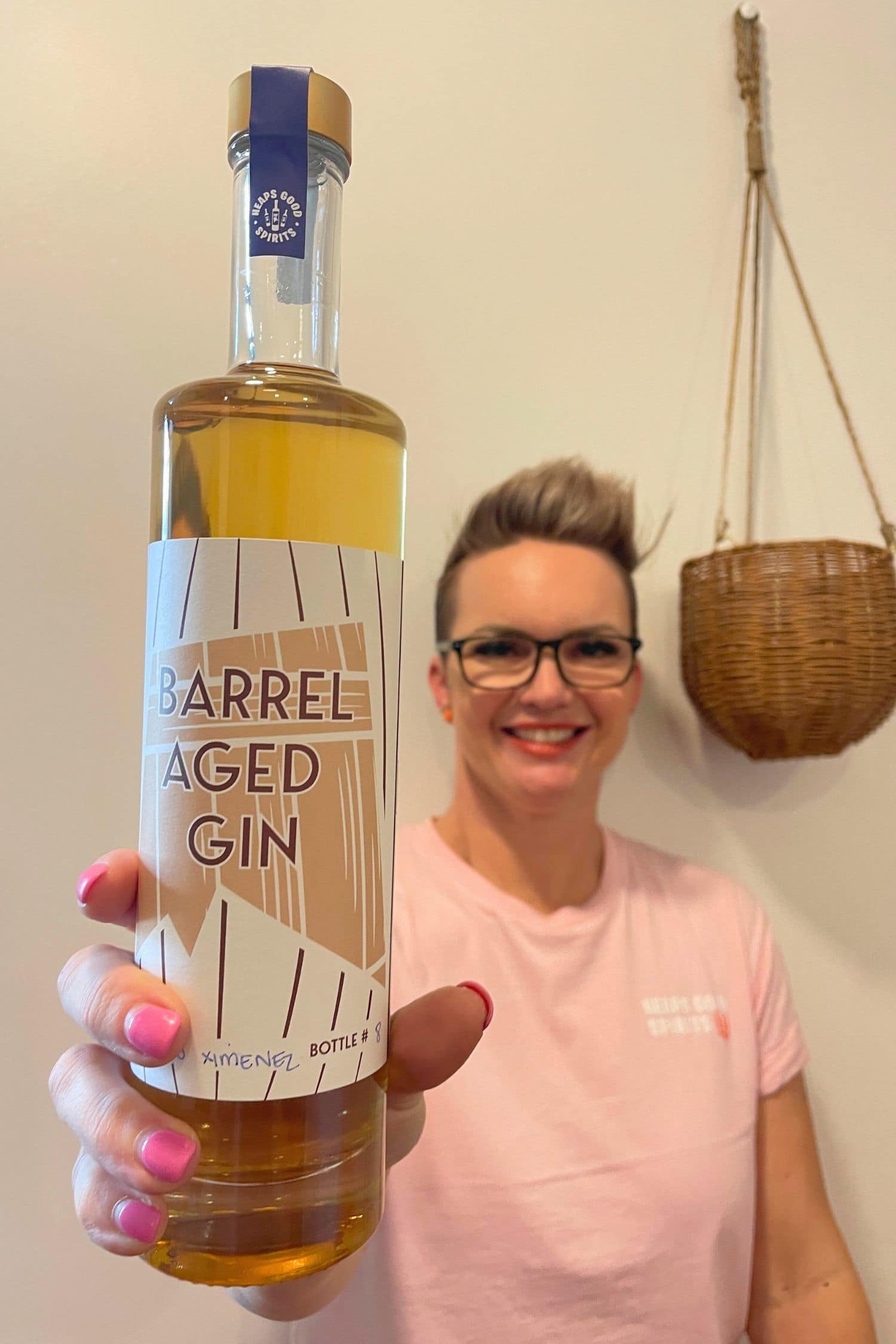 Founder holding up bottle of Heaps Good Barrel Aged Gin