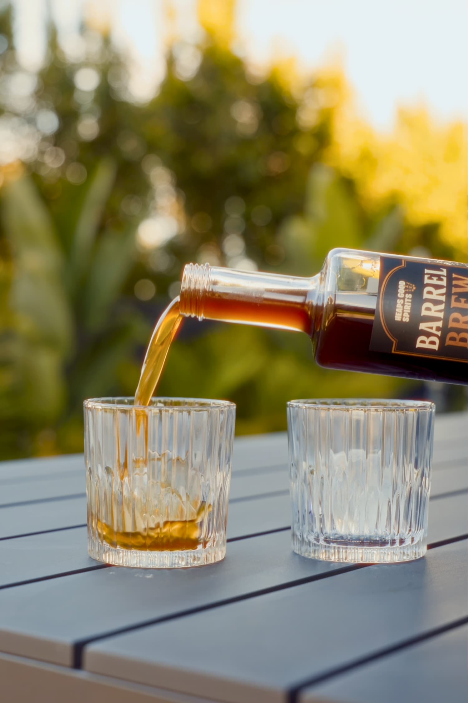 Bottle of Barrel Brew whisky coffee liqueur being poured into a glass straight over ice.