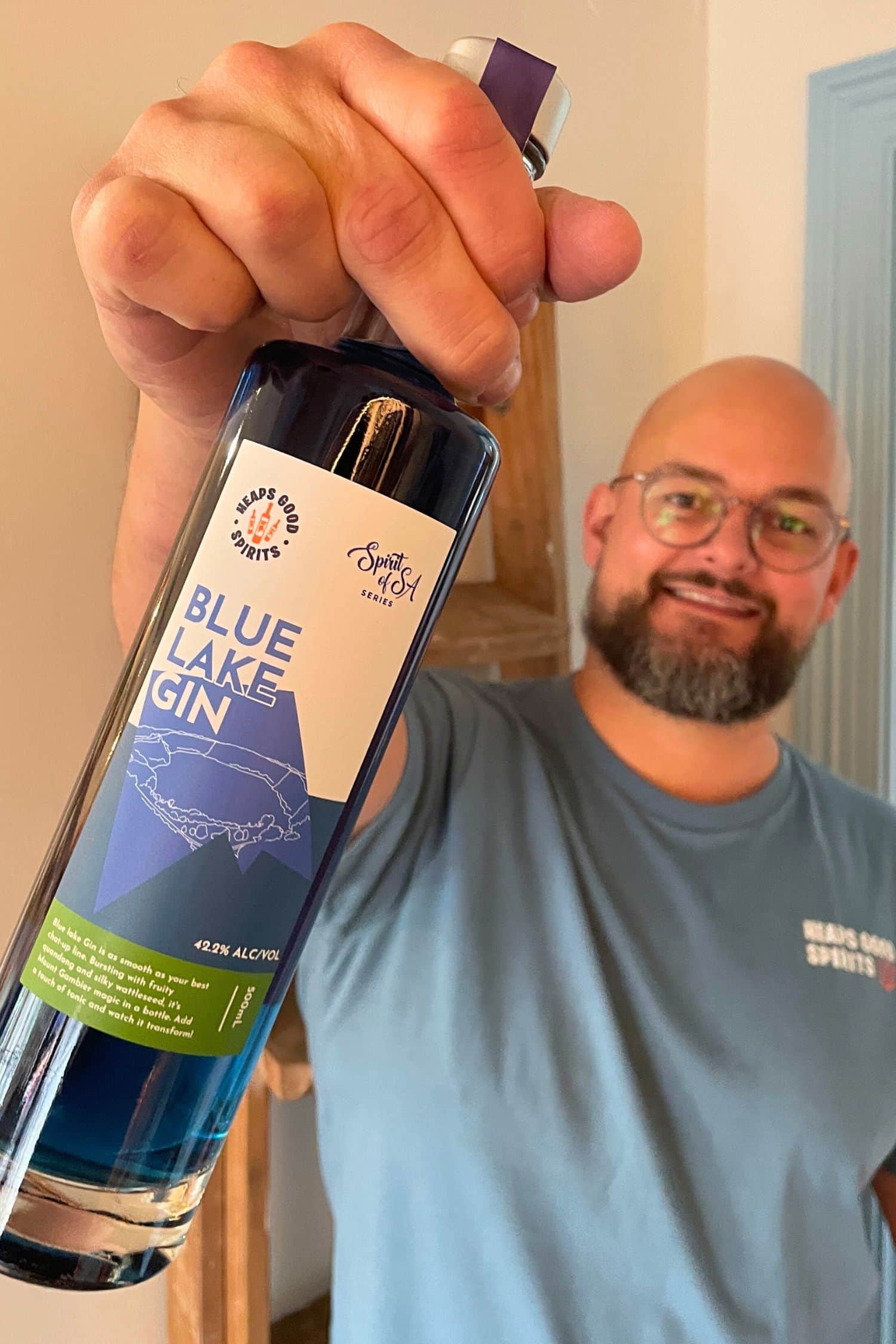 Founder holding Blue Lake Gin bottle, showcasing vibrant blue colour and Spirit of SA Series label.