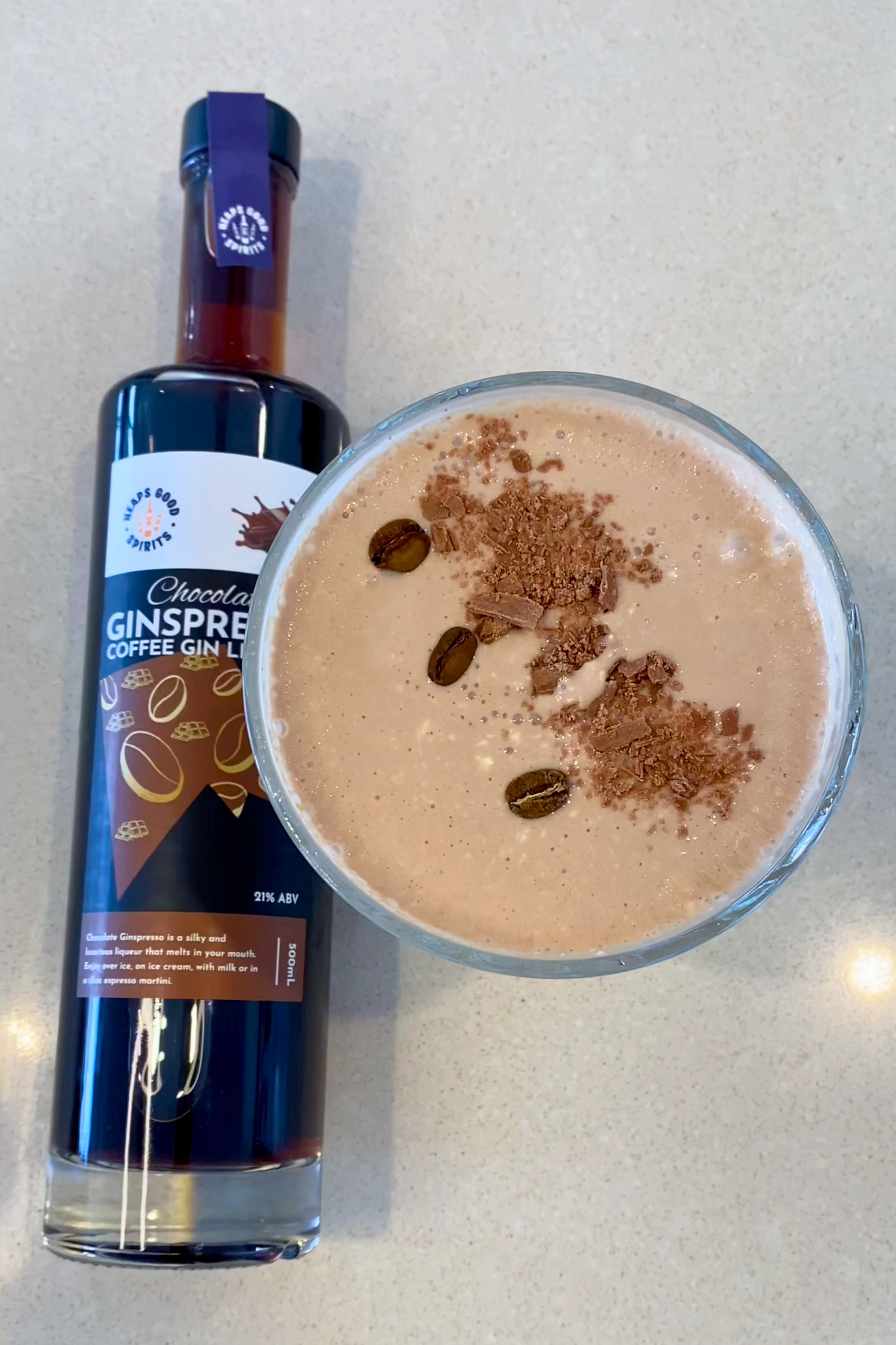 Chocolate Ginspresso bottle next to a chocolate espresso martini cheesecake made using it as the star ingredient