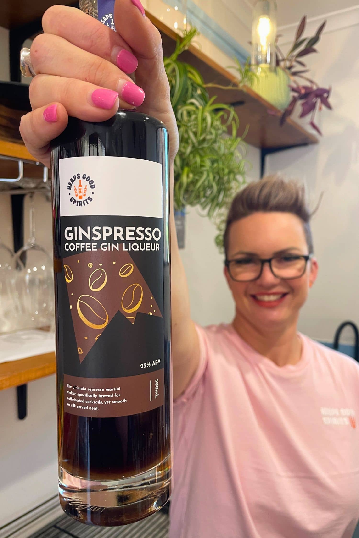 Founder holding Ginspresso coffee gin liqueur inside Adelaide Hills tasting room
