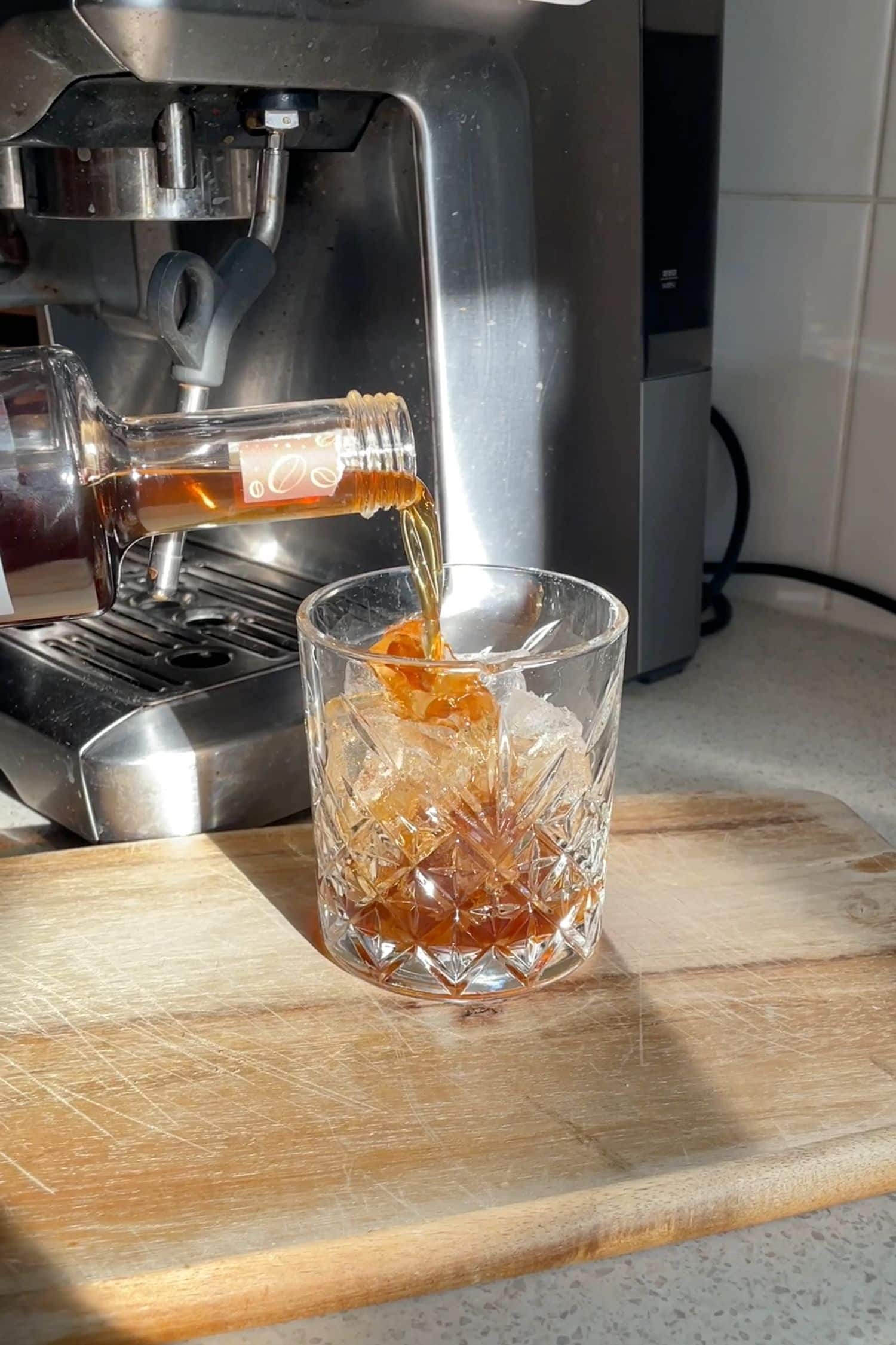 Ginspresso coffee gin liqueur poured over ice for easy espresso martini-style drink at home