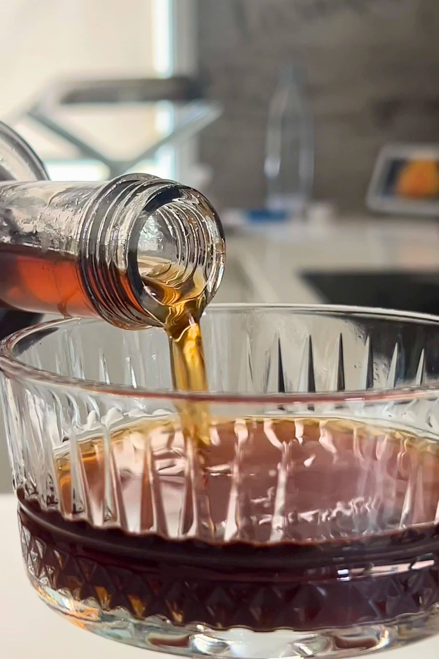 Salted Caramel Ginspresso coffee gin liqueur being poured into cocktail glass.