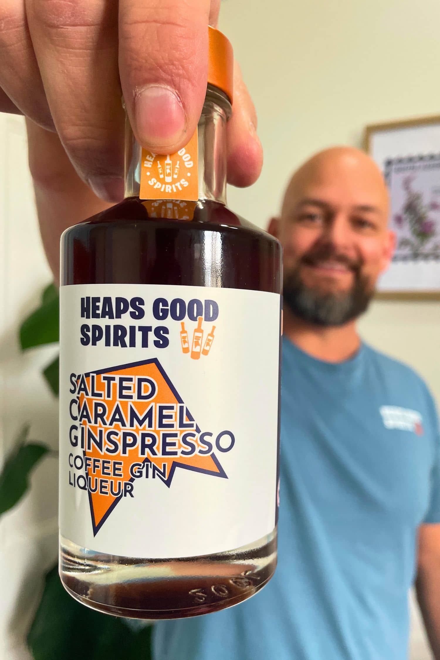 Founder holding Heaps Good Spirits Salted Caramel Ginspresso Coffee Gin Liqueur