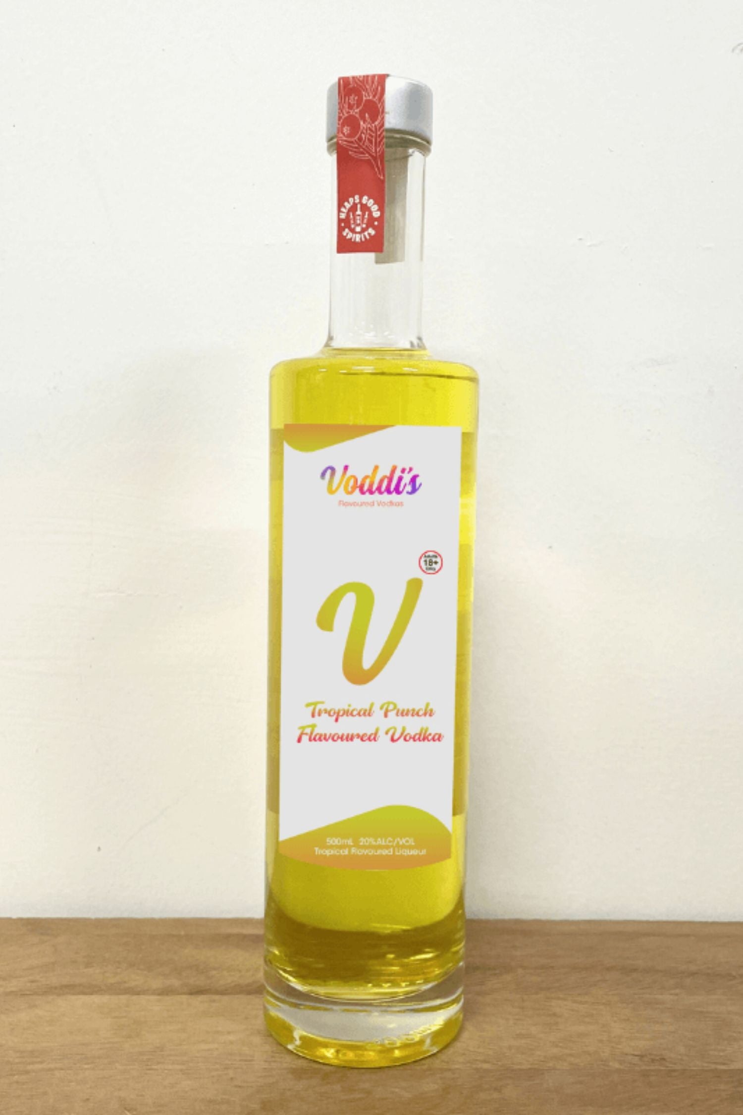 Voddi’s Tropical Punch Flavoured Vodka 500ml bottle on wooden surface against white background