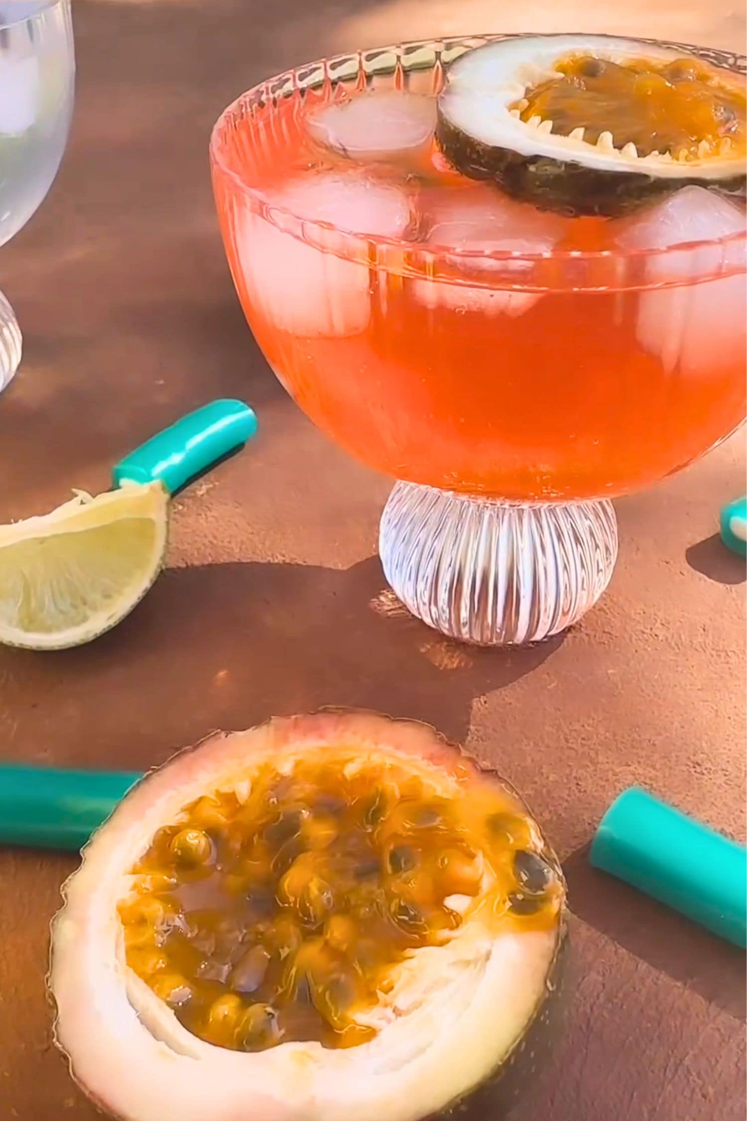 Voddi’s Tropical Punch Vodka cocktail in coupe glass with ice and fresh passionfruit garnish