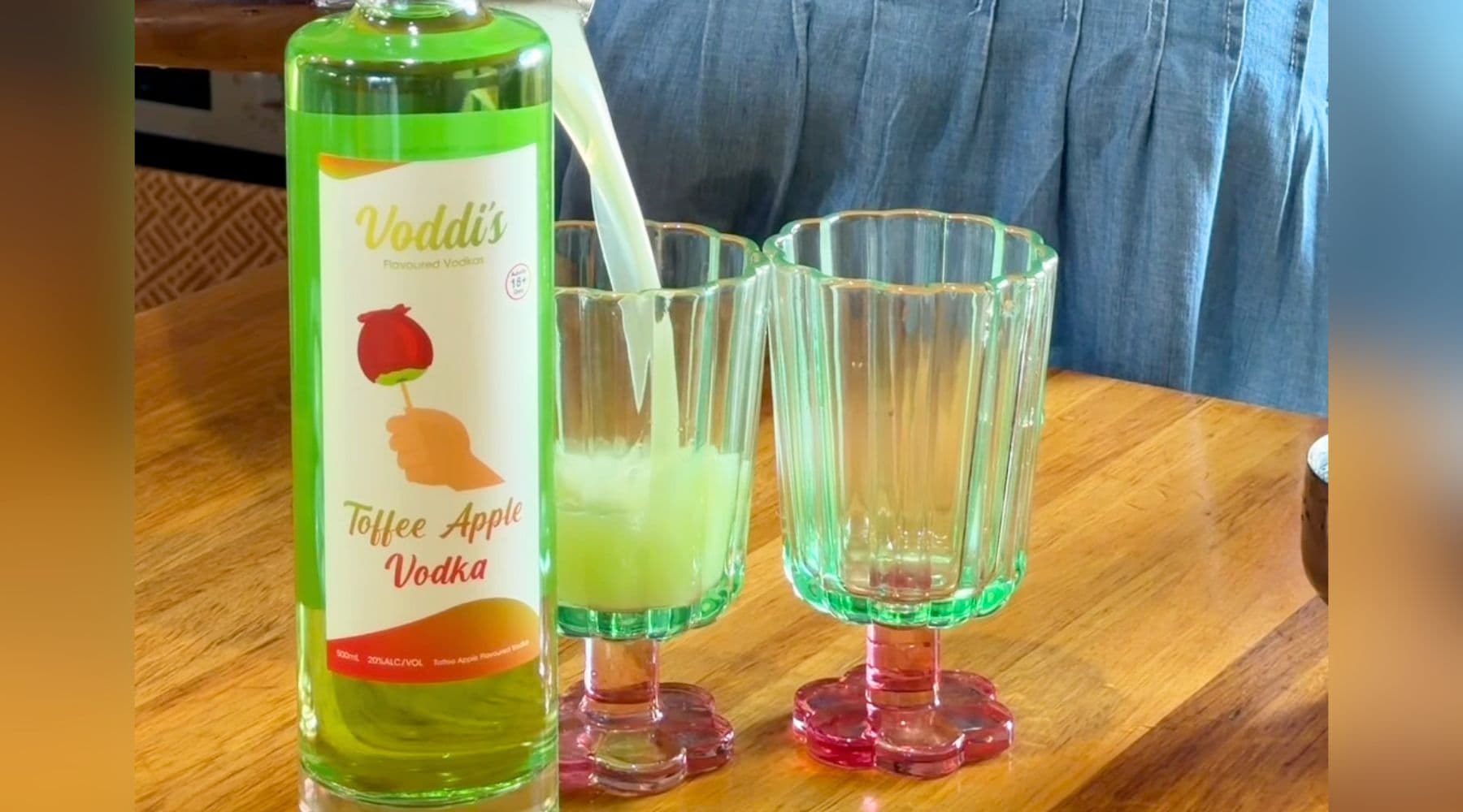 Apple Vodka & Juice cocktail served next to bottle of Toffee Apple Vodka by Heaps Good Spirits.