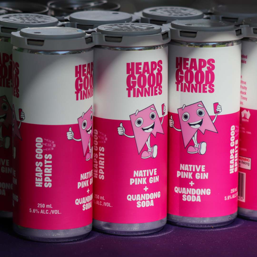 Heaps Good Native Pink Gin &amp; Quandong Soda tinnies set up on a bar.