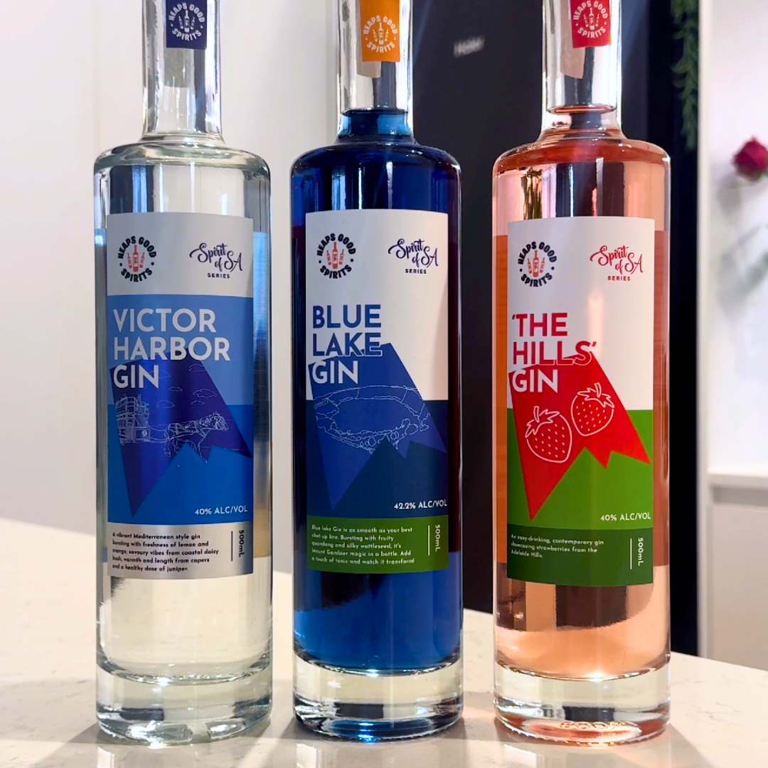Three Spirit of SA Series gins stood up next to each other: Victor Harbor Gin, Blue Lake Gin and The Hills Gin, by Heaps Good Spirits.