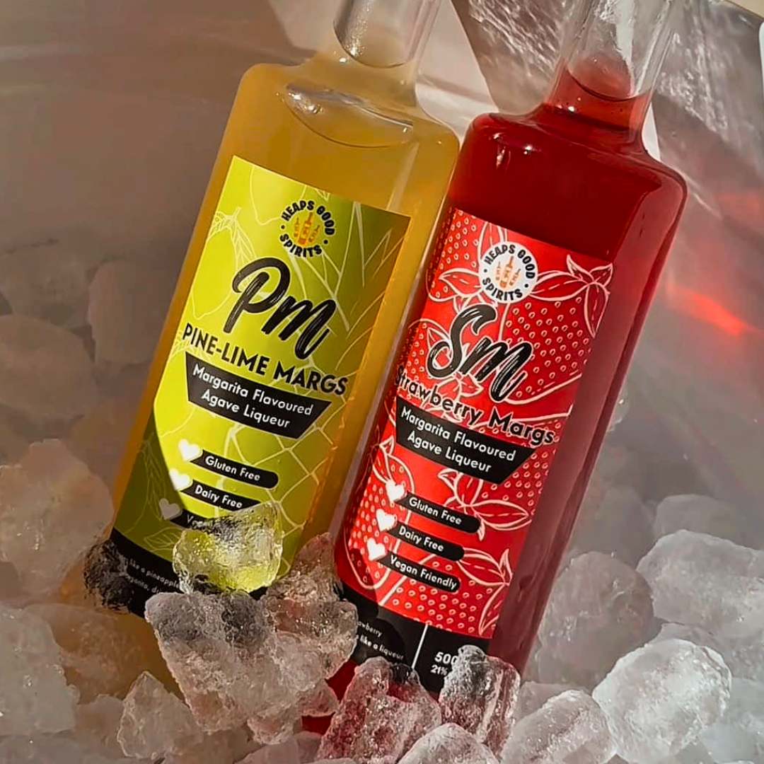 Pine-Lime Margs and Strawberry Margs bottles chilled in a bucket of ice.