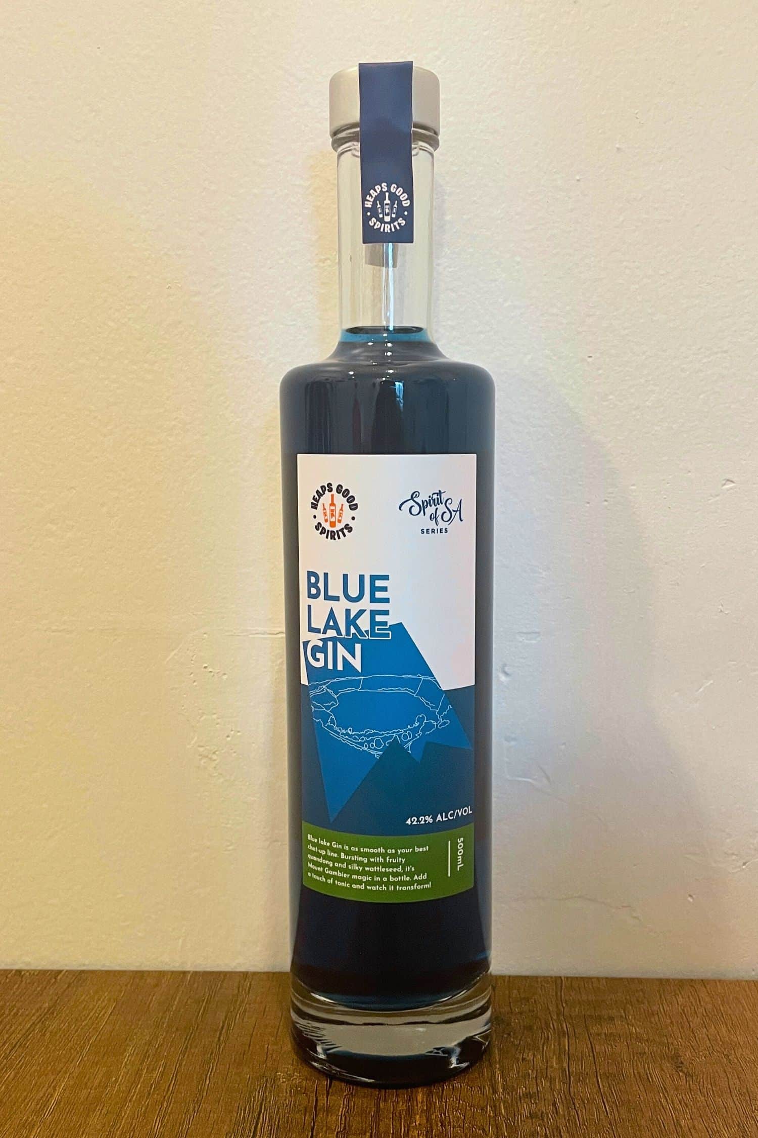 Heaps Good Spirits Blue Lake Gin bottle standing on wooden surface with white background, Spirits of SA series, 42.2% ABV.