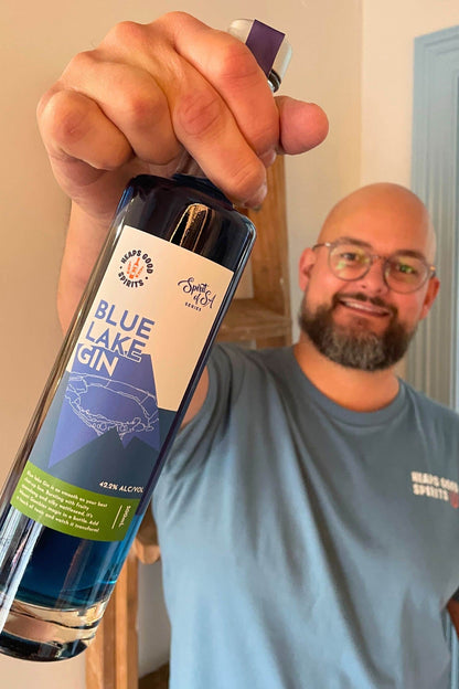 Founder holding Blue Lake Gin bottle, showcasing vibrant blue colour and Spirit of SA Series label.