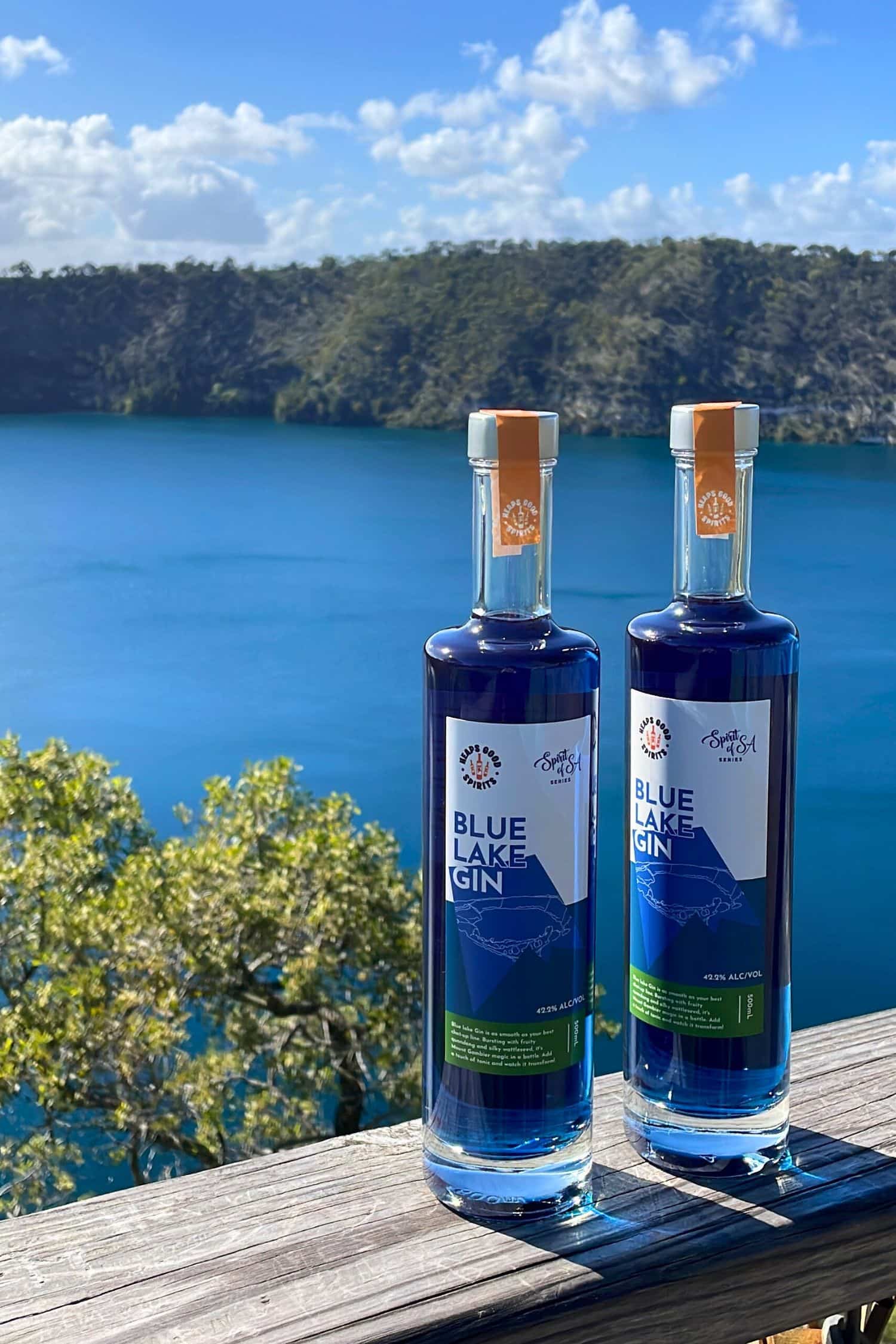 Two bottles of Blue Lake Gin overlooking the Blue Lake in Mount Gambier, South Australia.