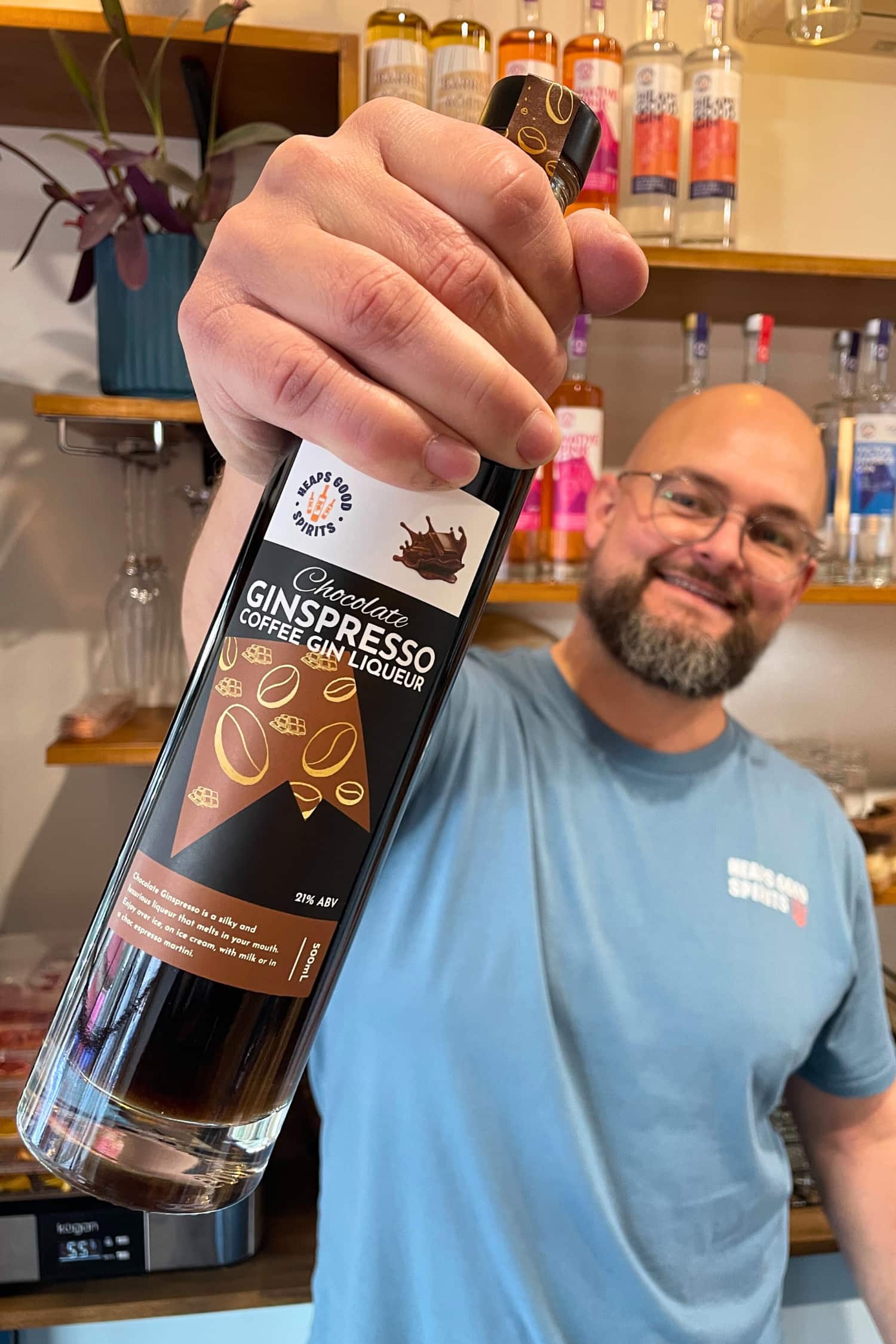 Founder holding Chocolate Ginspresso coffee gin liqueur at tasting room