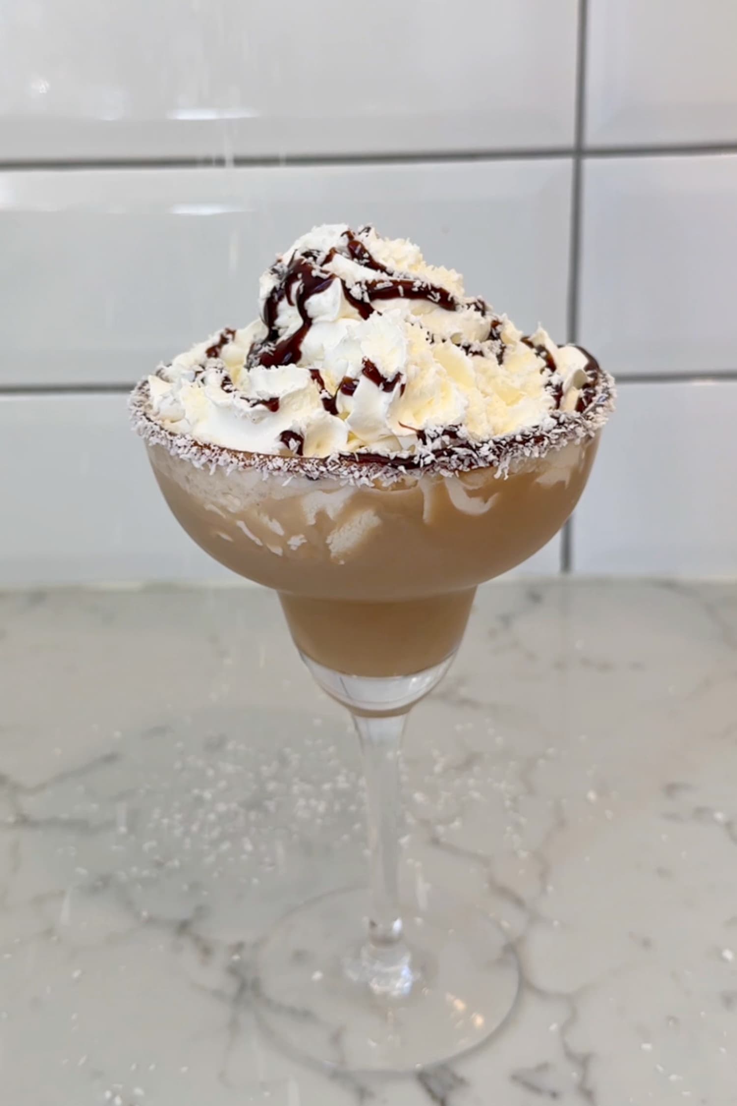 Chocolate Ginspresso dessert cocktail with whipped cream and chocolate drizzle