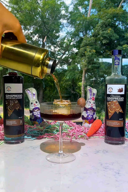 Chocolate Ginspresso espresso martini being poured into coupe glass with Easter chocolate bunnies.
