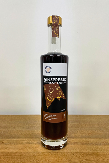 Bottle of Ginspresso Coffee Gin Liqueur on a wooden surface with a white background