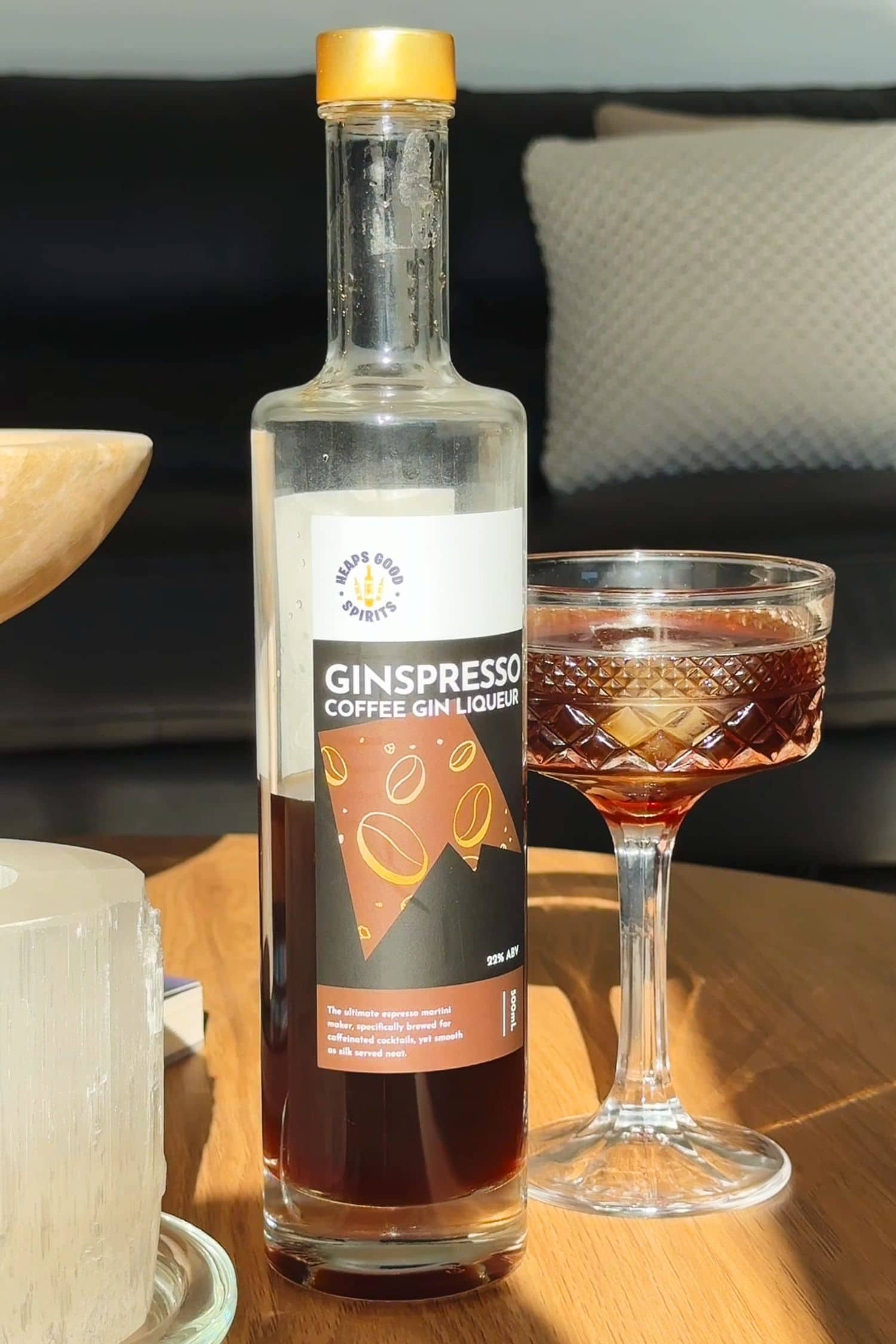 Ginspresso coffee gin liqueur bottle beside serving straight over ice in coupe glass