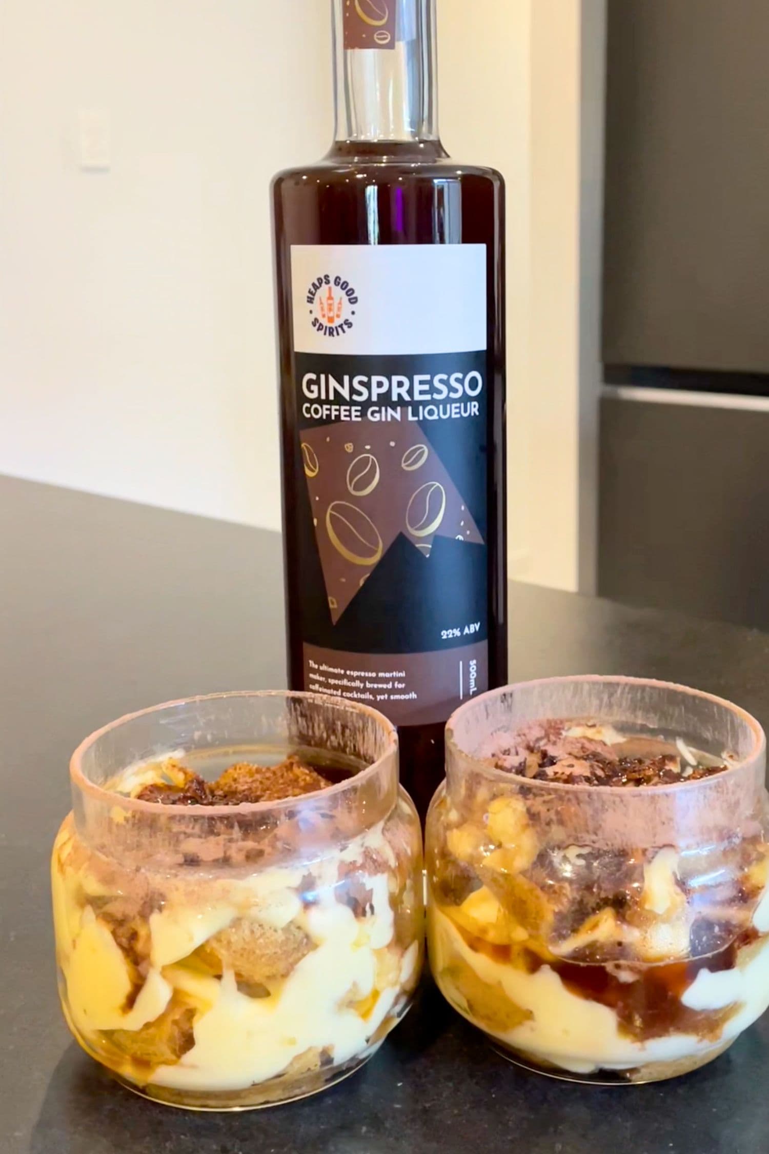 Bottle of Ginspresso coffee gin liqueur with two single servings of gin tiramisu made using it.