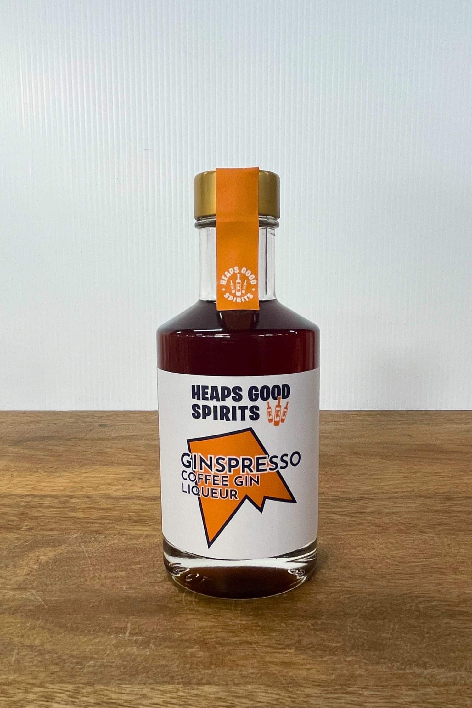 Heaps Good Spirits Ginspresso Coffee Gin Liqueur bottle on wooden surface against white background