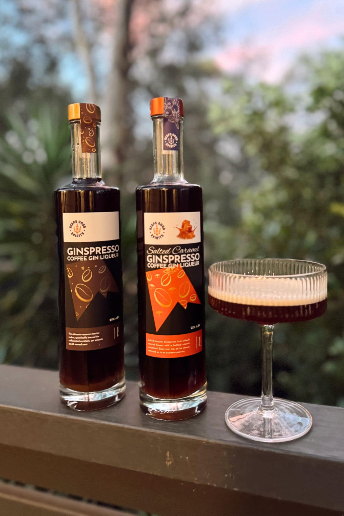 Ginspresso and Salted Caramel Ginspresso coffee gin liqueur bottles with espresso martini cocktail outdoors.