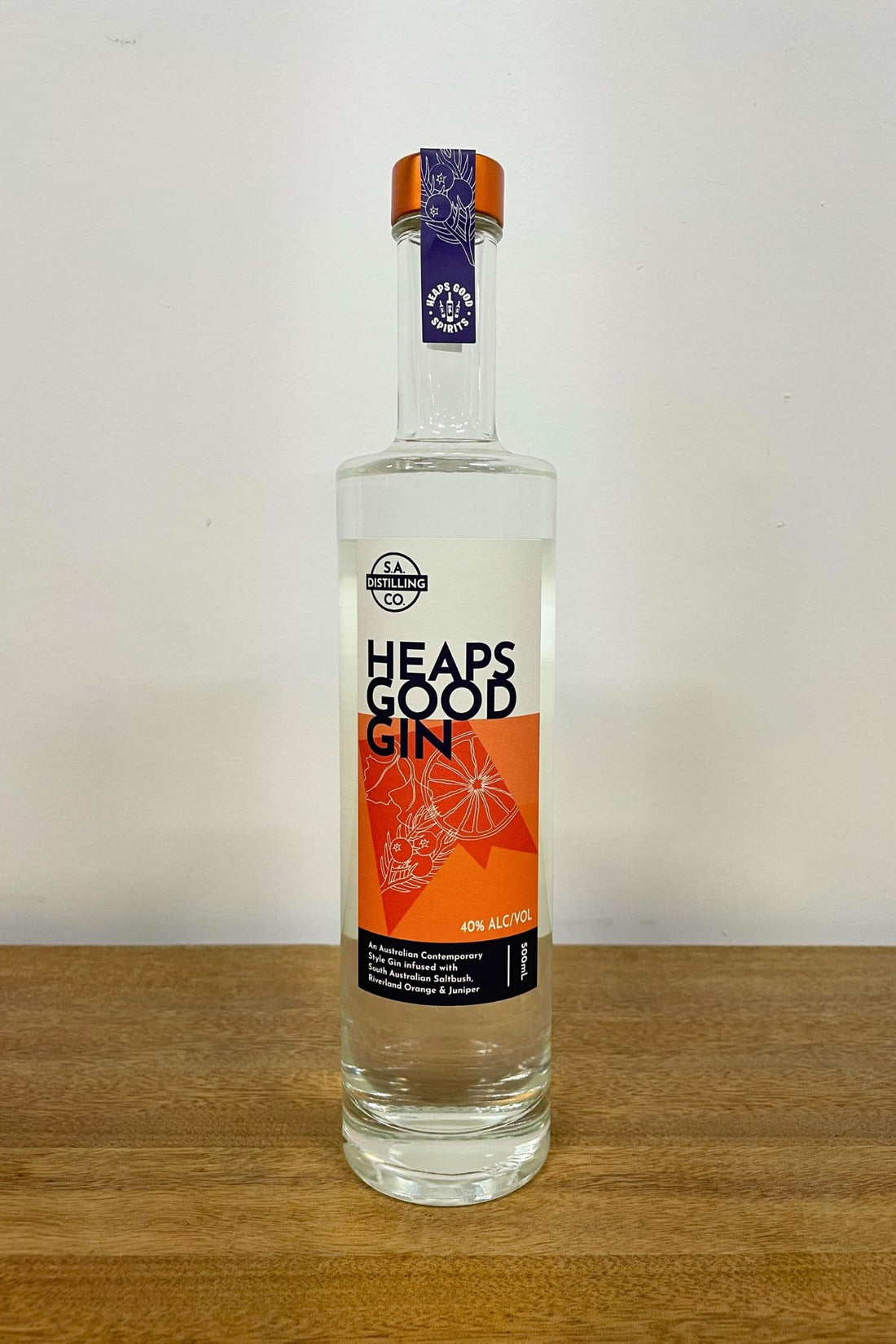 Heaps Good Gin 500ml bottle on wooden surface against white background