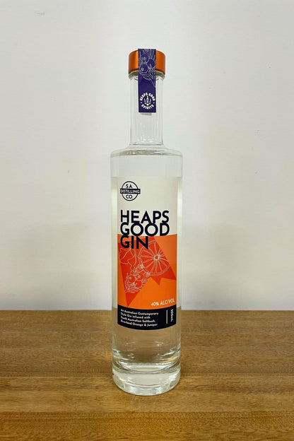 Heaps Good Gin 500ml bottle on wooden surface against white background