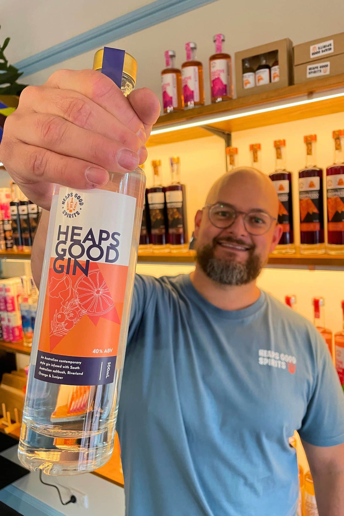 Founder holding Heaps Good Gin bottle inside Adelaide Hills tasting room