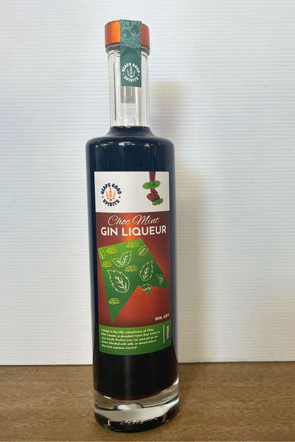 Bottle of Choc Mint Gin Liqueur on a wooden surface with a white background