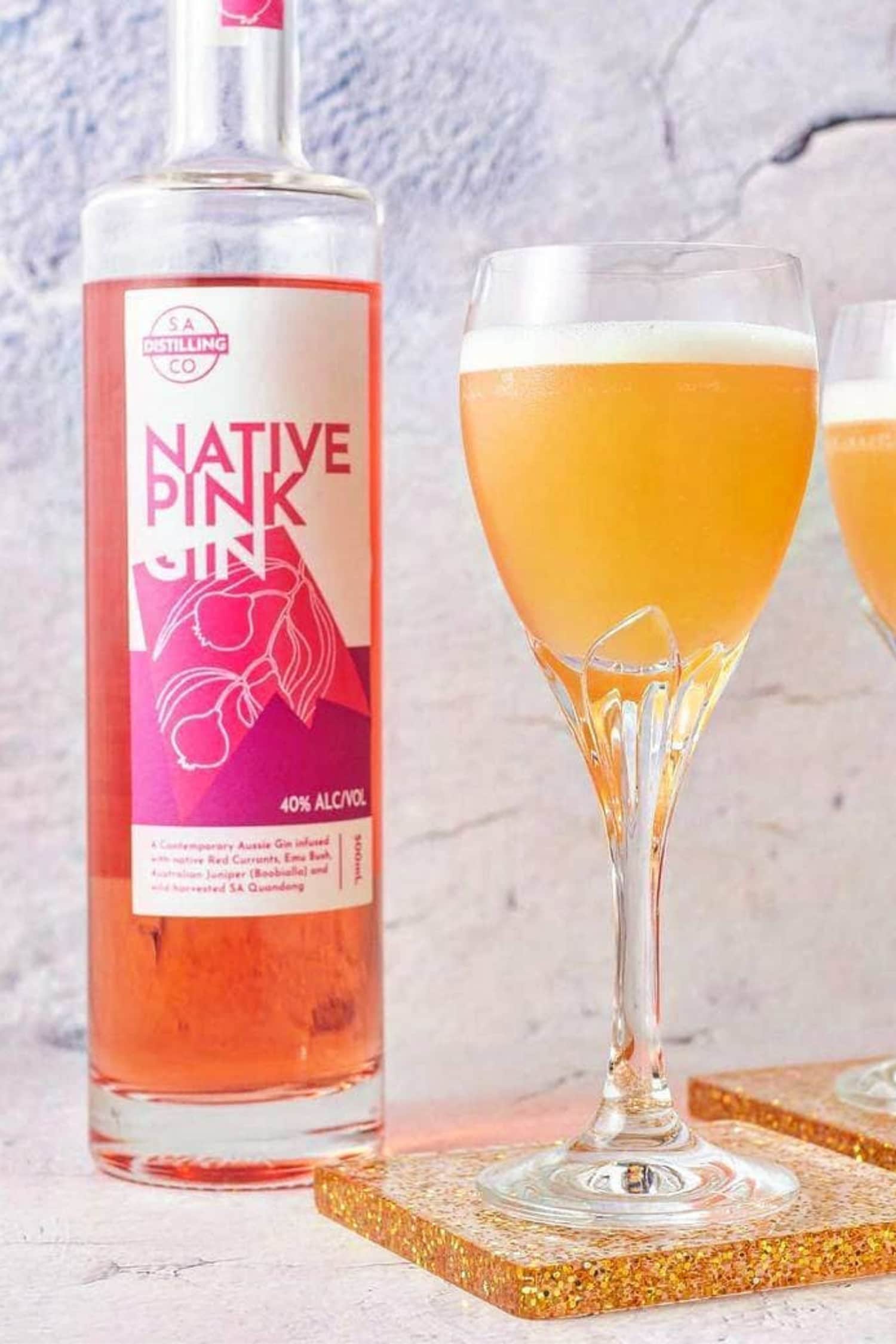 Native Pink Gin by Heaps Good Spirits served in bright orange cocktails.