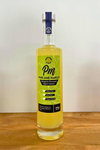 Heaps Good Pine-Lime Margs 500ml margarita flavoured agave liqueur bottle on wooden surface against white background