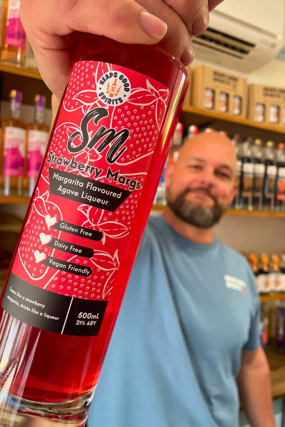 Founder holding Heaps Good Strawberry Margs bottle inside Adelaide Hills tasting room