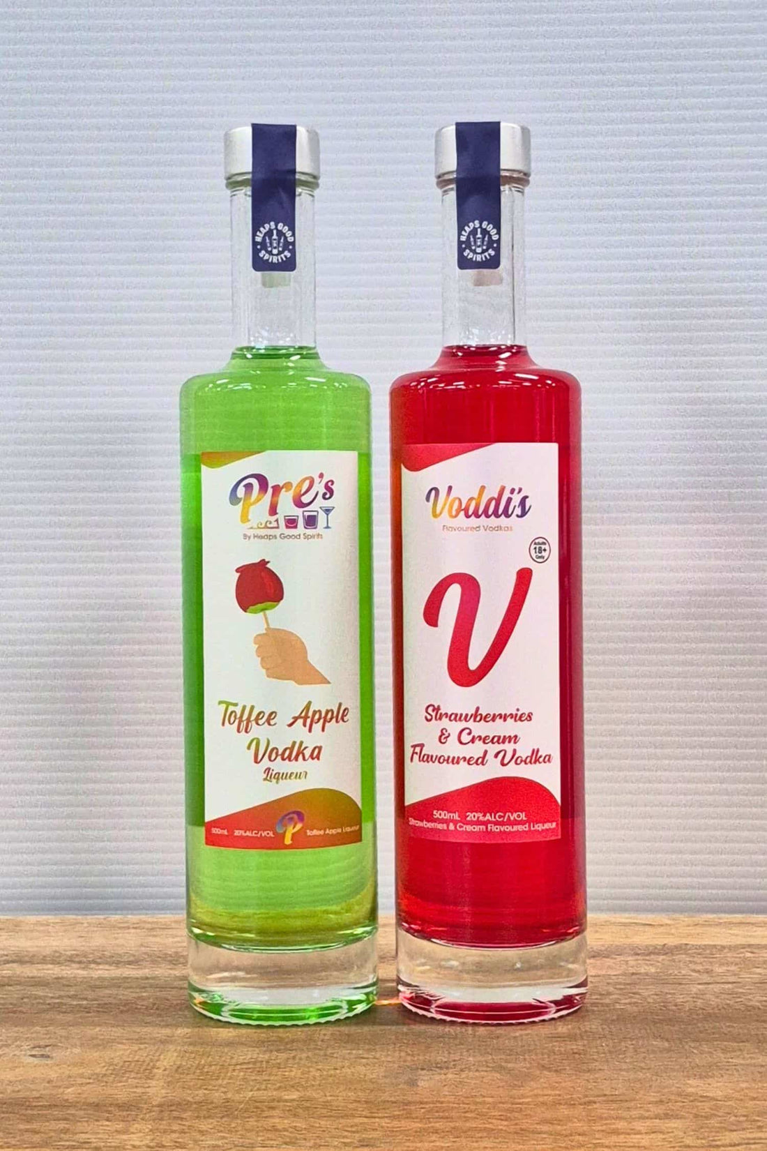 Voddi’s Toffee Apple and Strawberries &amp; Cream flavoured vodka bottles side by side