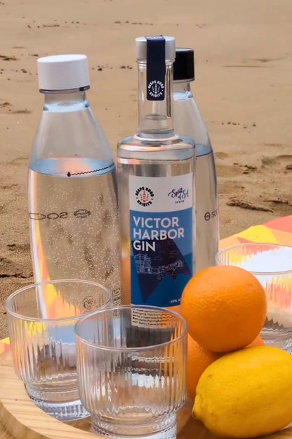 Heaps Good Victor Harbor Gin with soda water and fresh citrus on beach picnic board