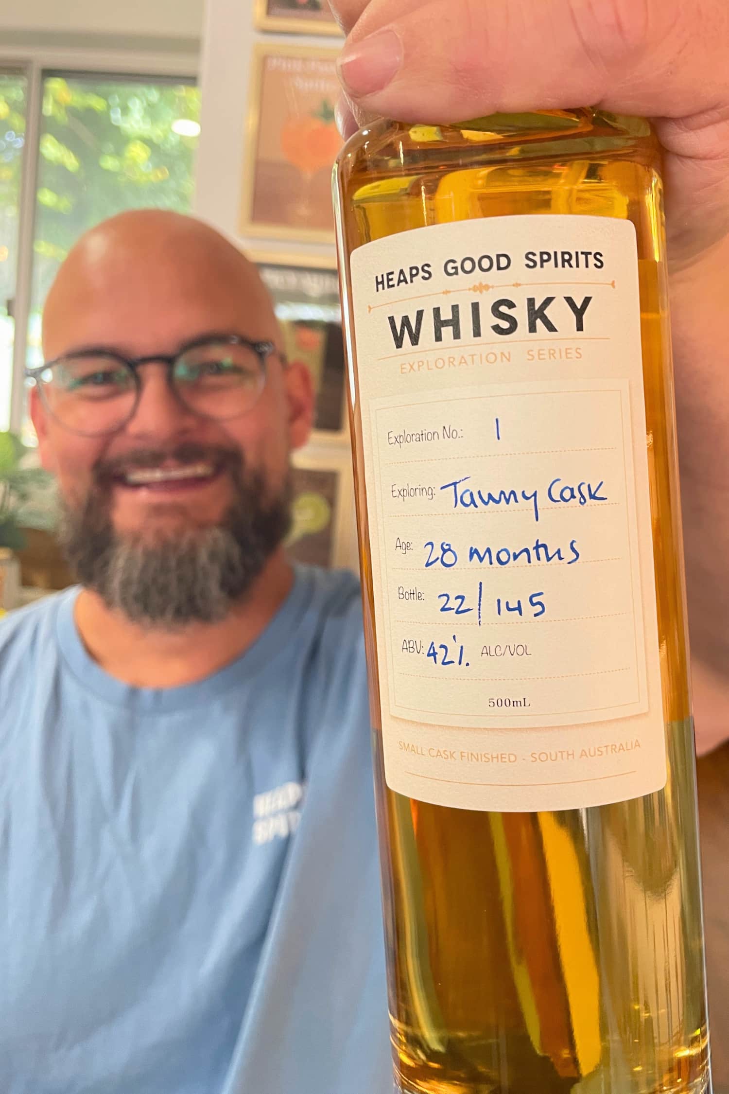 Bottle of Tawny Cask Whisky held in hand by Heaps Good Spirits founder Greg.